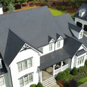 Aerial view of a modern home with a slate black roof, showcasing architectural details and landscaping, relevant to roofing services in Germantown, MD.