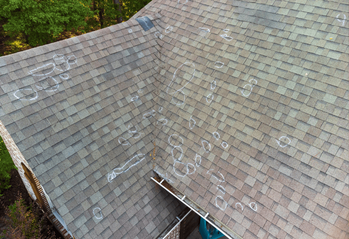 Roof with chalk markings indicating potential damage, highlighting warning signs of roofing problems, relevant to roofing maintenance and inspection articles.